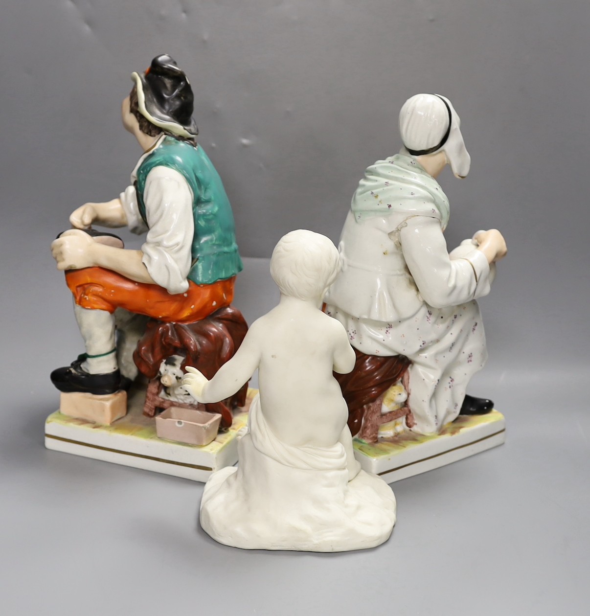 A Copeland Parian figure of a putti (hand a.f.) and two Staffordshire figures, tallest 32cm